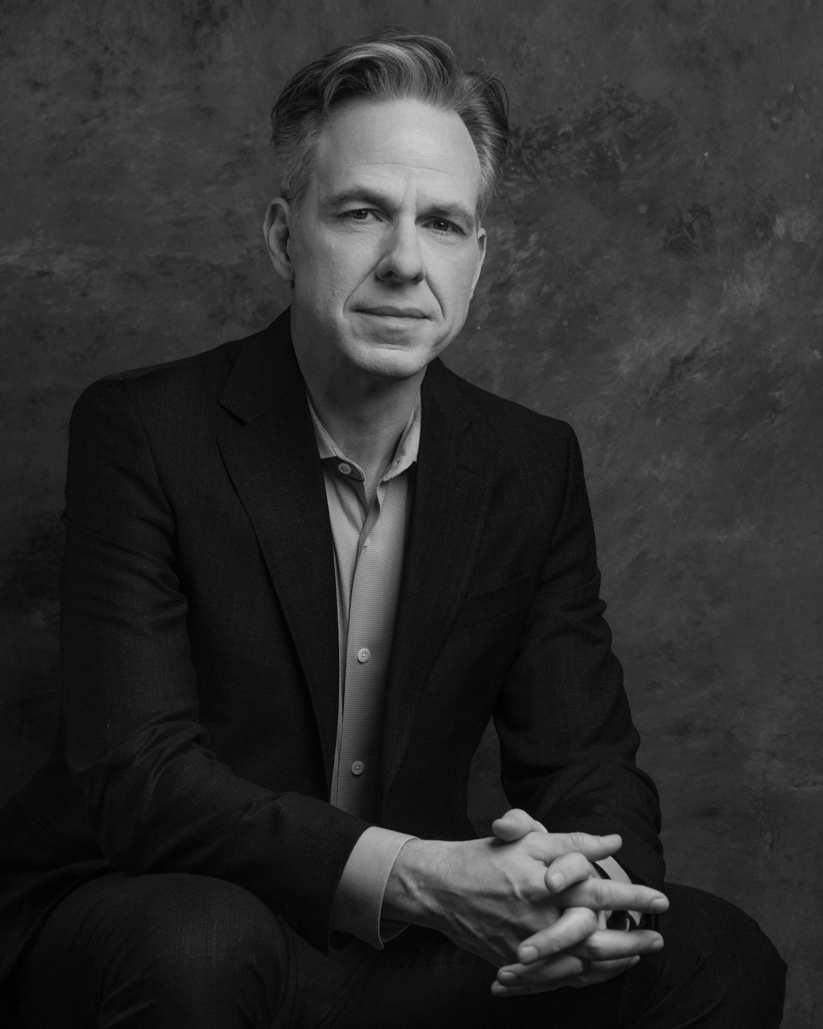 Jake Tapper, seated, black and white portrait