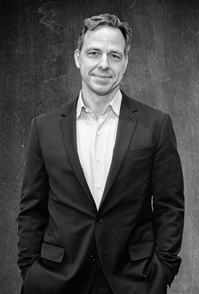 Jake Tapper, standing, black and white portrait