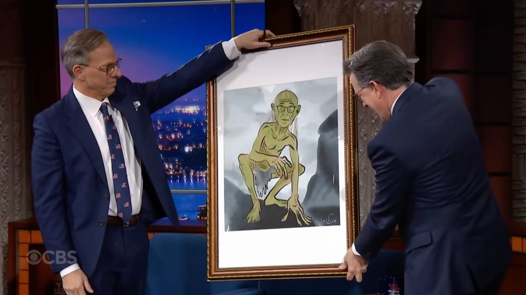 Jake Tapper presenting a painting to Stephen Colbert