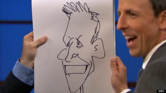 Seth Meyers holding the caricature Jake Tapper drew of him live